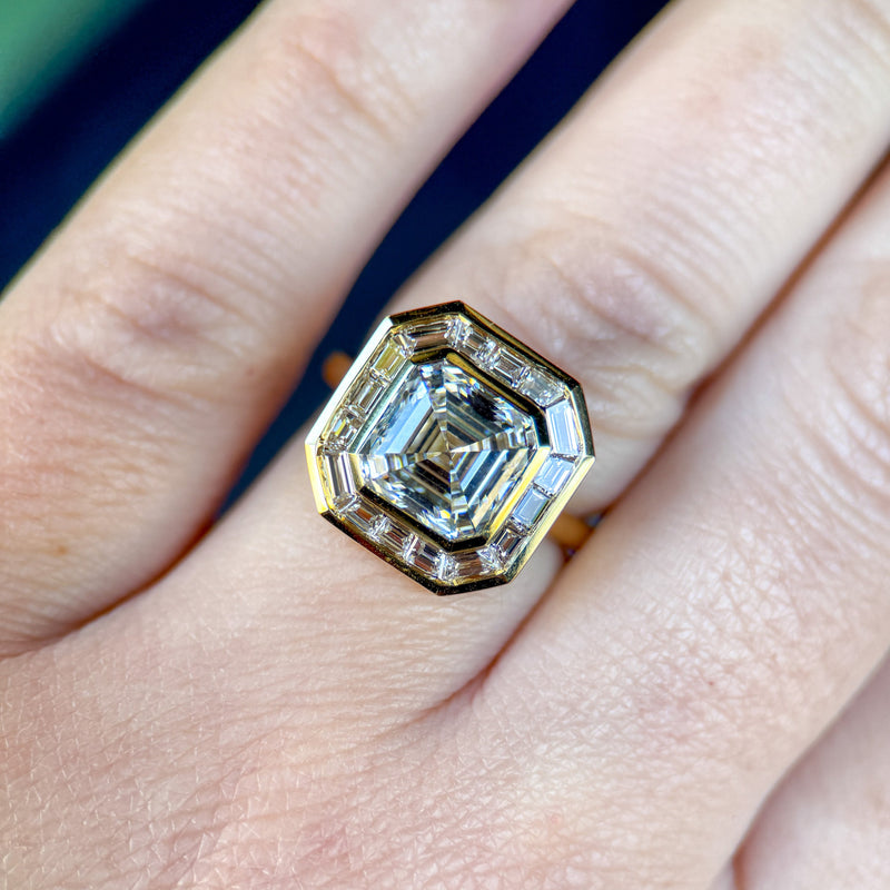 Gold ring with a diamond on a finger